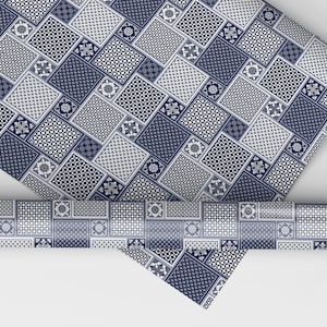 May include: Blue and white patterned wrapping paper with a geometric design. The paper is rolled up and the edges are visible.