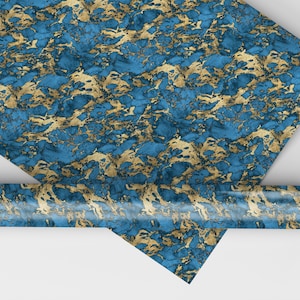 May include: A roll of blue and gold marbled wrapping paper. The paper has a metallic sheen and is perfect for wrapping gifts.
