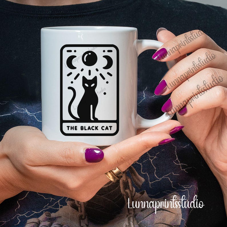 May include: White ceramic mug with a black and white illustration of a black cat with a crescent moon and stars above it. The text "The Black Cat" is printed below the image.