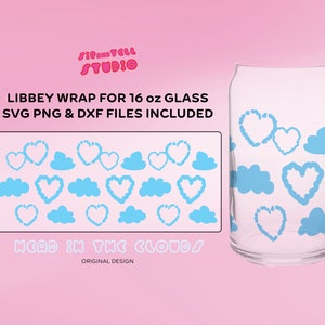 May include: Clear glass Libbey can-shaped glass with a blue heart and cloud design. The image includes a design template with the text "LIBBEY WRAP FOR 16 oz GLASS SVG PNG & DXF FILES INCLUDED" and "HEAD IN THE CLOUDS".
