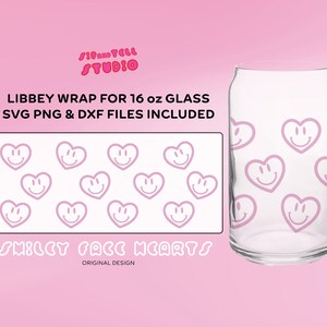 May include: A clear glass can-shaped cup with a pink smiley face heart design. The design is repeated on a separate rectangular graphic. Text on the image reads "LIBBEY WRAP FOR 16 oz GLASS SVG PNG & DXF FILES INCLUDED" and "SMILEY FACE HEARTS".