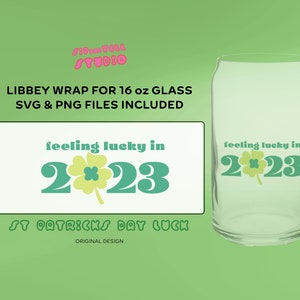 May include: A clear glass Libbey wrap for a 16 oz glass, featuring the text "feeling lucky in 2023" with a shamrock design. The design is in green and light yellow, perfect for St. Patrick's Day. SVG and PNG files are included.