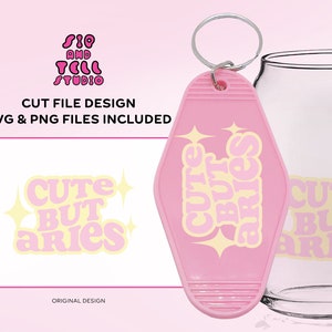 May include: A pink motel-style keychain with the text "Cute But Aries" in a retro font, along with starburst graphics. The image also includes a glass and a design with the same text. The words "Cut File Design" and "SVG & PNG Files Included" are also visible.