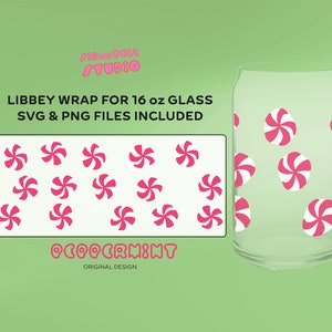 May include: A clear glass with a peppermint candy design. The design includes pink and white swirled candies. The image also shows a design template with multiple peppermint candies and the text "LIBBEY WRAP FOR 16 oz GLASS SVG & PNG FILES INCLUDED".