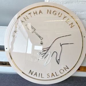 Nail Salon Sign in Beige Color with Golden Lettering silver mirror logo and Golden Rim. All mounting material included