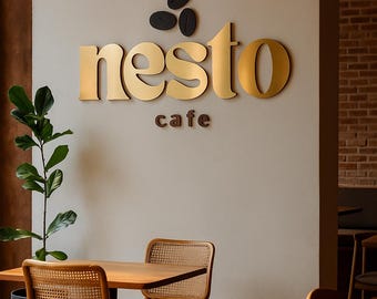 May include: Interior shot of a cafe with a sign that reads "nesto cafe" in gold lettering. The cafe has wooden tables and chairs with woven backs and seats. A potted plant is visible on the left side of the image.