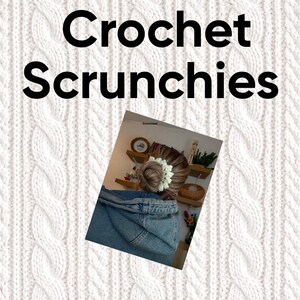 May include: The image displays the text "Crochet Scrunchies" in bold black letters. A person's hair is styled in a bun, adorned with a white crochet scrunchie. The background features a white cable-knit pattern.