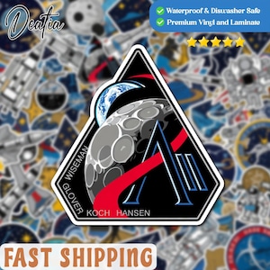May include: A black, white, and red sticker with a space theme. The sticker shows the moon, Earth, and a stylized letter "A". The names "WISEMAN", "GLOVER", and "KOCH HANSEN" are printed on the sticker. It is waterproof and dishwasher safe.