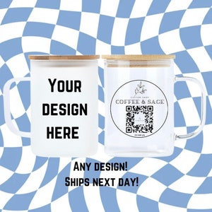 May include: Two white ceramic mugs with bamboo lids. One mug has the text "YOUR DESIGN HERE" and the other mug has a circle with the text "CUSTOM SHOP COFFEE & SAGE" and a QR code. The mugs are on a blue and white checkered background.