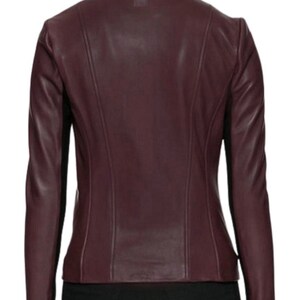 May include: A burgundy leather jacket with a stand-up collar and a zipper closure.