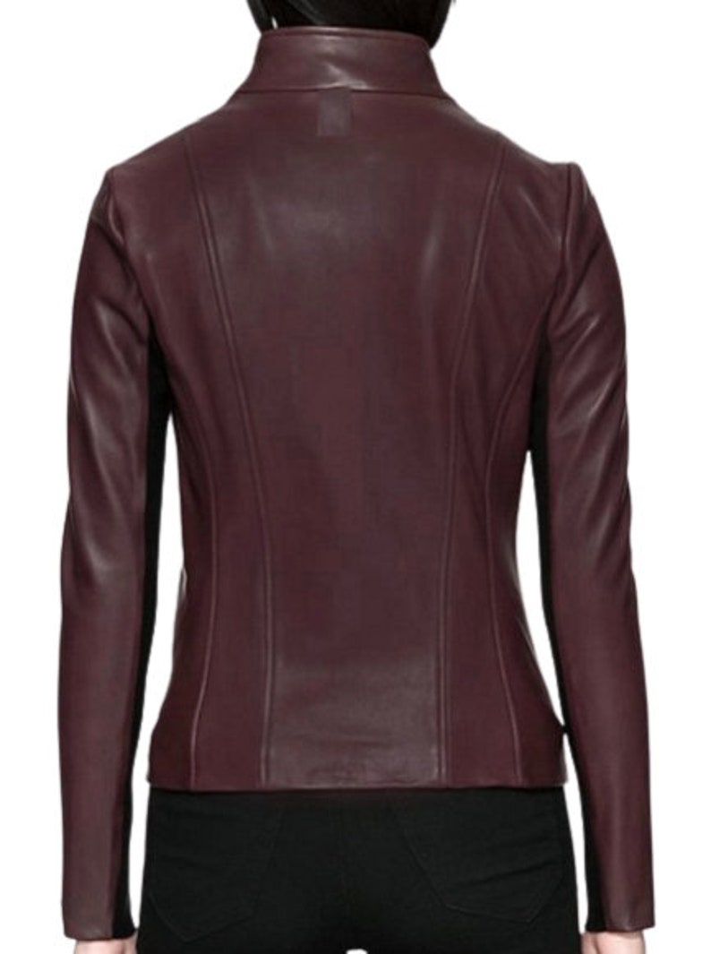 May include: A burgundy leather jacket with a stand-up collar and a zipper closure.