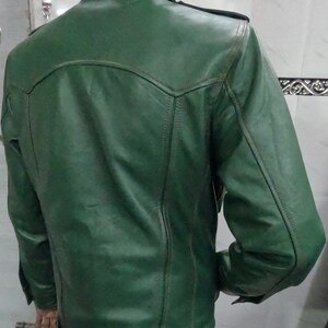 May include: A dark green leather jacket with a zipper closure and buttoned pockets.