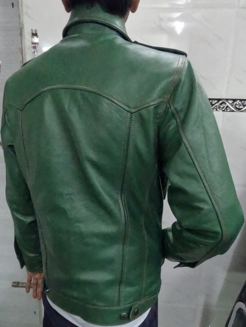 May include: A dark green leather jacket with a zipper closure and buttoned pockets.