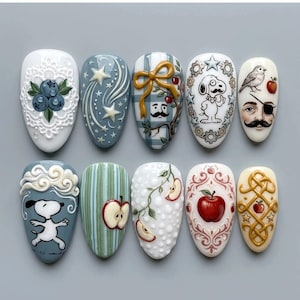 May include: A set of ten painted fingernails with various designs. The designs include blueberries, stars, Snoopy, apples, and decorative patterns. Colors include white, blue, green, and red. Each nail has a unique, detailed design.