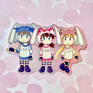 May include: Three cartoon characters wearing bunny-themed hats. The character on the left is wearing a blue hat with the text "6th Grade" on it. The character in the middle is wearing a pink hat with the text "6th Grade" on it. The character on the right is wearing a yellow hat with the text "6th Grade" on it.