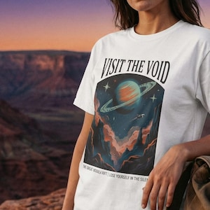 May include: A white ceramic mug with a black handle and the text "But First, Coffee" in a black, bold font. The mug is sitting on a wooden surface. The mug is approximately 4 inches tall.