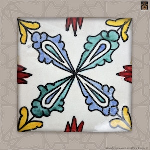 Peut inclure: Un carreau de céramique blanc avec un motif floral bleu, vert, jaune et rouge. Le carreau a un design symétrique avec quatre motifs répétitifs.