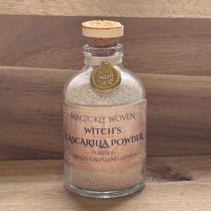 May include: A white ceramic mug with a black handle and the text "But First, Coffee" in a black, bold font. The mug is sitting on a white surface.