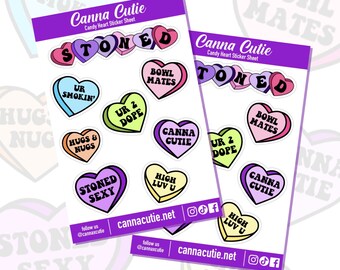 May include: A sheet of stickers featuring colorful heart-shaped designs with various phrases related to cannabis culture, such as "stoned", "canna cutie", "ur 2 dope", and "high luv u". The stickers are printed on white paper with a purple border.