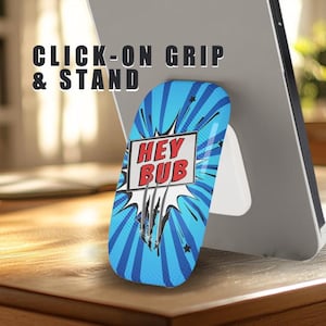 May include: A blue and white comic-style phone grip and stand with the words "HEY BUB" in a white box. The grip is attached to a tablet, and the text "CLICK-ON GRIP & STAND" is above the grip.