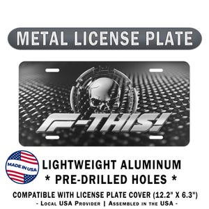 May include: Black and white metal license plate with a skull design and the text "F-THIS!". The plate is made of lightweight aluminum and has pre-drilled holes. The license plate is compatible with a cover that measures 12.2" x 6.3".