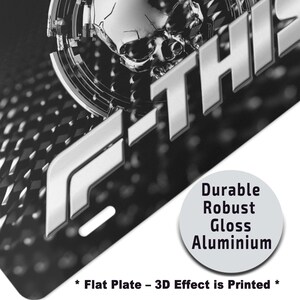 May include: A close-up of a black and silver metal plate with the text "F-THIS" in a bold, silver font. The plate has a diamond pattern and a circular graphic with the words "Durable, Robust, Gloss, Aluminium". The text "Flat Plate - 3D Effect is Printed" is also visible.