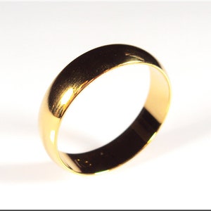 May include: A simple gold wedding band with a smooth, polished finish.