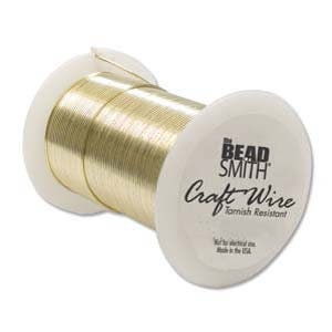 May include: A spool of gold-colored craft wire, labeled "The Bead Smith Craft Wire Tarnish Resistant".