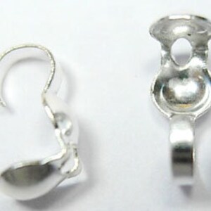 May include: Two silver-toned metal clasps for jewelry making. Each clasp has a hook on one end and a loop on the other.
