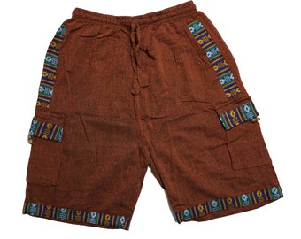May include: Brown cotton shorts with a drawstring waist and side pockets. The shorts have a colourful patterned trim around the waistband and legs.