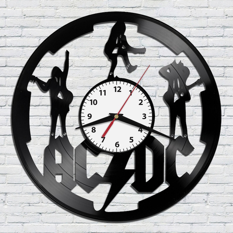 May include: Black vinyl record clock featuring the AC/DC logo and silhouettes of the band members. The clock face is white with black numbers and hands.
