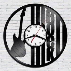 May include: Black vinyl record clock with a silhouette of an electric guitar and the word "Rock" in large letters. The clock face is white with black numbers and hands.