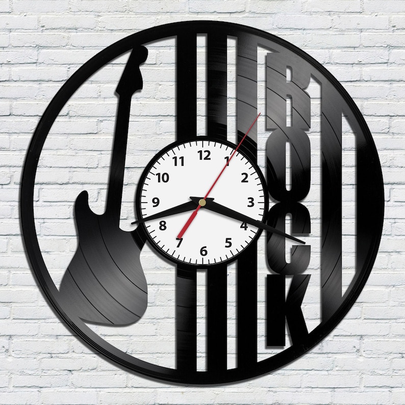 May include: Black vinyl record clock with a silhouette of an electric guitar and the word "Rock" in large letters. The clock face is white with black numbers and hands.