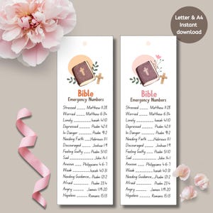 May include: Two white bookmarks with the text "Bible Emergency Numbers" and a list of Bible verses for various emotional states. Each bookmark features a small illustration of a book and cross.