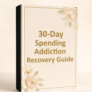 May include: A book titled "30-Day Spending Addiction Recovery Guide" with a cream-colored cover and gold text. The cover is decorated with floral illustrations in the corners. The spine is black.