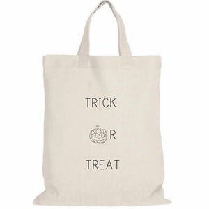 May include: A white canvas tote bag with the text "Trick or Treat" and a simple line drawing of a jack-o'-lantern.