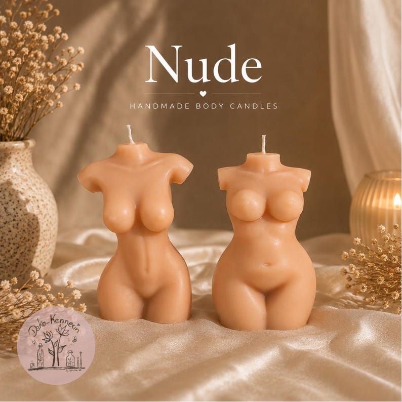May include: Two light beige torso-shaped candles with a single wick at the top of each. The text Nude and HANDMADE BODY CANDLES is printed above the candles. The candles are smooth and feature a human-like form with defined chest and hip areas.