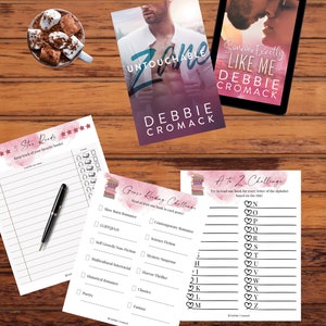May include: A set of printable reading challenge cards with pink and white watercolour backgrounds. The cards feature a list of genres and a list of letters of the alphabet. The text on the cards reads "Genre Reading Challenge" and "A to Z Challenge".