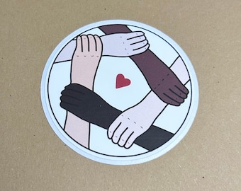 May include: A white circular sticker featuring four arms of varying skin tones clasped together around a red heart at the centre.