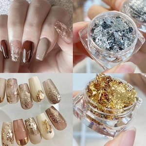 May include: Close-up of two sets of fingernails with different nail art designs. One set features gold and silver glitter nail polish with small, clear rhinestones. The other set features a variety of colors and designs, including a nude base with gold glitter, a white base with gold glitter, and a black base with gold glitter.
