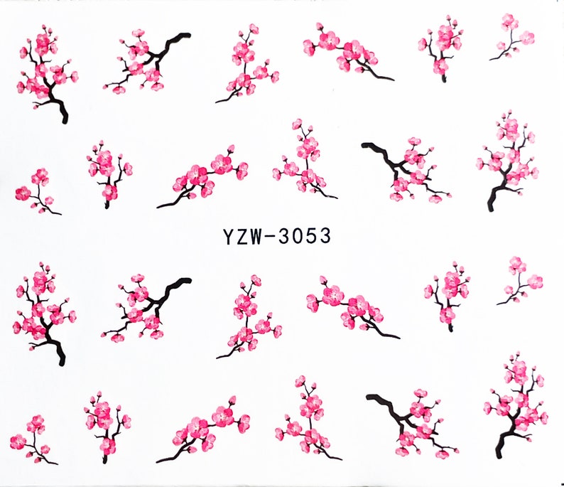 May include: A sheet of pink and black nail art stickers featuring cherry blossom designs. The sheet includes the text "YZW-3053".