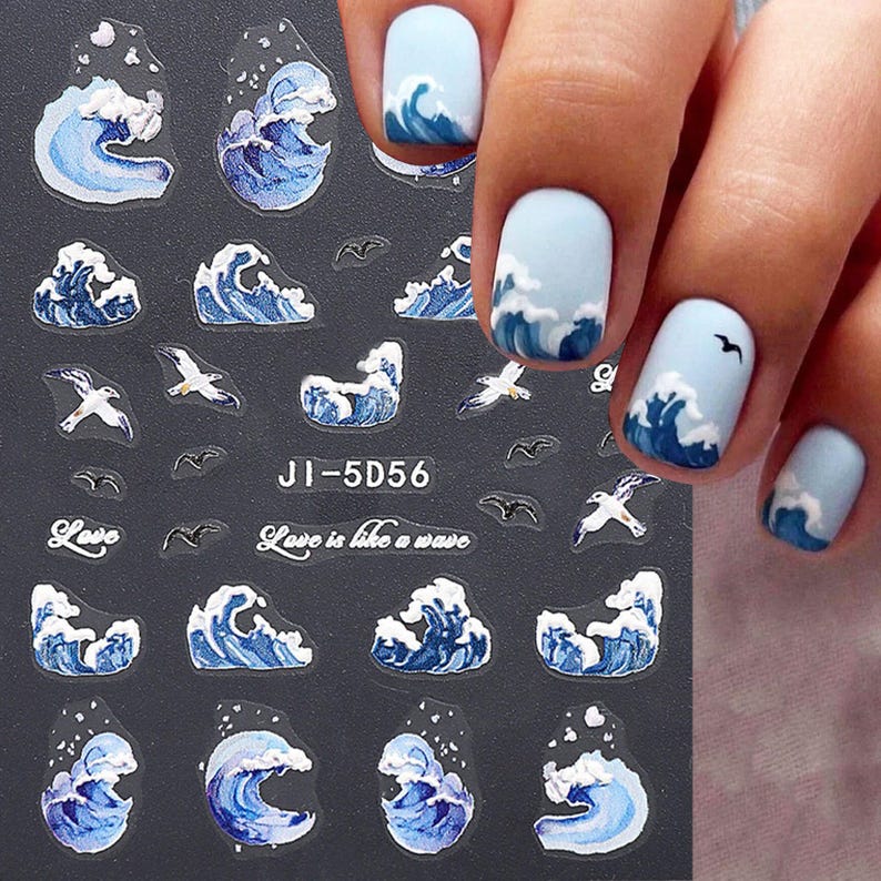 May include: A sheet of nail art stickers with a blue and white wave design and seagulls. The sheet also includes the text "Love is like a wave" and the code "JI-5D56".