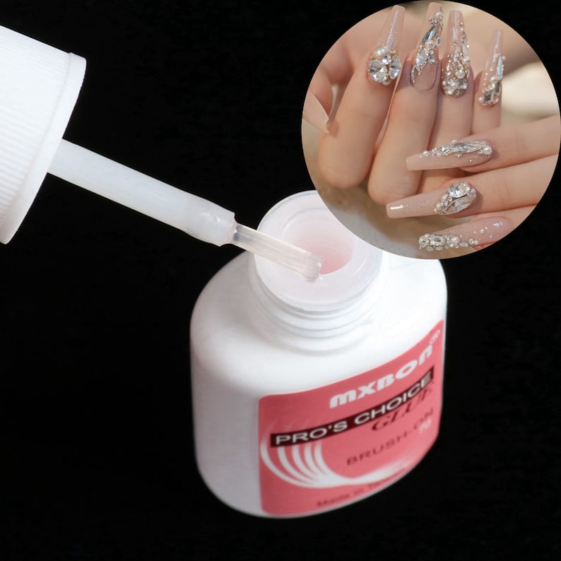 Op de afbeelding: Een witte fles nagellijm met een roze dop en een doorzichtige druppelaar. De fles heeft een roze etiket met de tekst "MXBON PRO'S CHOICE GLUE BRUSH ON".