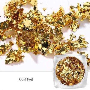 May include: A small jar filled with gold leaf flakes. The jar is clear and has a white label that says "Gold Foil".