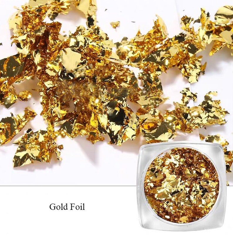 May include: A small jar filled with gold leaf flakes. The jar is clear and has a white label that says "Gold Foil".