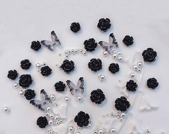 May include: Black and white butterfly and rose embellishments. These small, decorative charms are perfect for adding a touch of elegance to crafts, jewelry, and other projects.