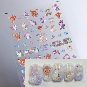 Peut inclure: Une feuille d'autocollants pour ongles avec divers personnages Disney, dont Bambi, Panpan et Fleur. Les autocollants sont sur un fond transparent et pr&ecirc;ts &agrave; &ecirc;tre appliqu&eacute;s sur les ongles. La feuille comprend &eacute;galement le texte "FANSIDE FS-044".