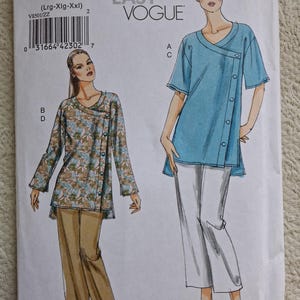 May include: A white ceramic mug with a black handle and the text "But First, Coffee" in a black, handwritten-style font. The mug is on a white surface.