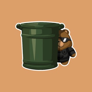 May include: A sticker featuring a cartoon bear wearing sunglasses and a black outfit, peeking from behind a dark green barrel. The bear is brown with a white outline, set against a tan background.