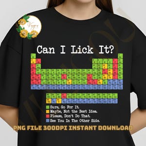 May include: Black t-shirt with the phrase "Can I Lick It?" above a periodic table of elements. The shirt includes color-coded text: "Sure, Go For It," "Maybe, Not the Best Idea," and "Please, Don't Do That."